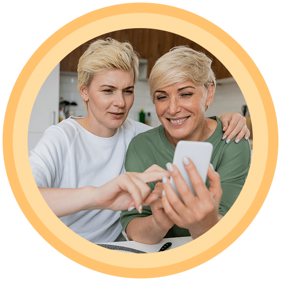 Two woman looking up hearing aids and services in their area
